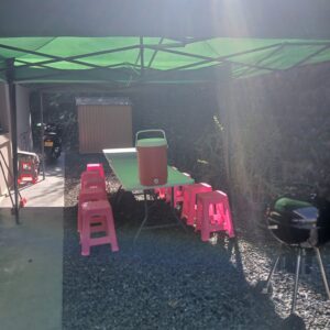 chapiteau vert, table blanche, tabouret rose et igloo orange installé